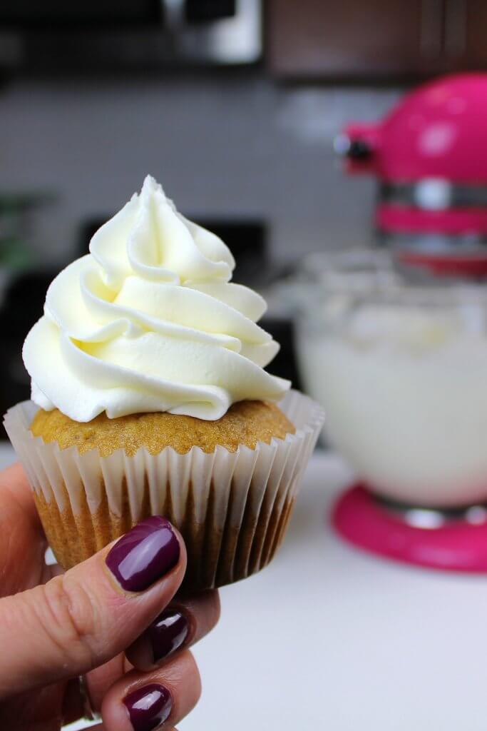 Buttercream frosted onto a pumpkin cupcake