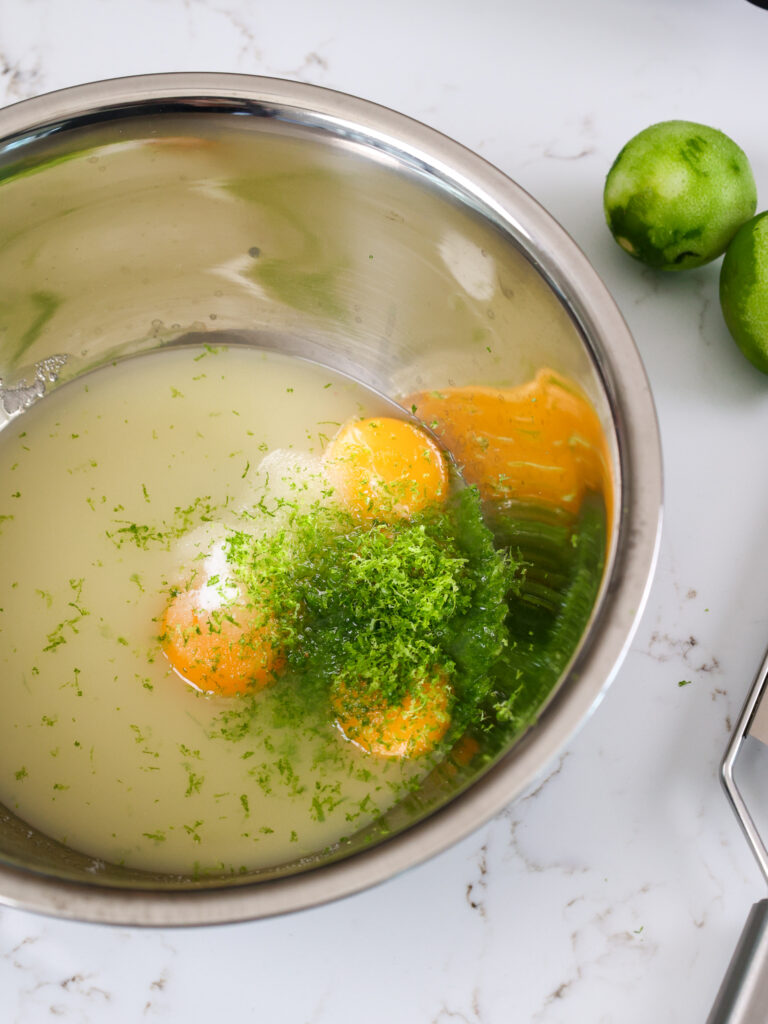 image of ingredients in a mixing bowl that are about about to be mixed together and cooked to make lime curd