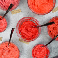 image of red buttercream frosting in a bowl