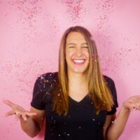 image of chelsey white of chelsweets, tossing sprinkles in the air