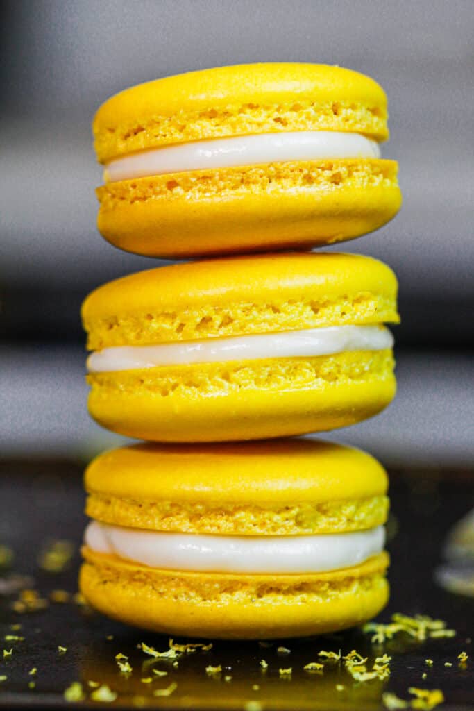 image of french lemon macarons filled with lemon curd and fresh lemon buttercream frosting