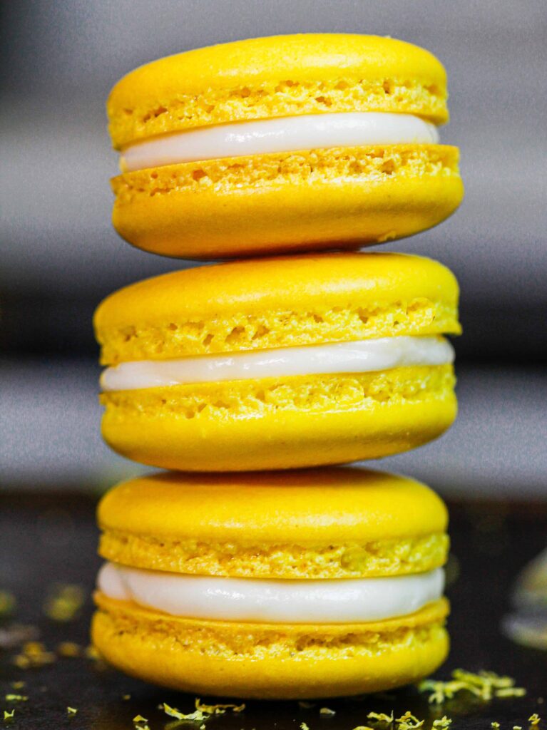 image of french lemon macarons filled with lemon curd and fresh lemon buttercream frosting