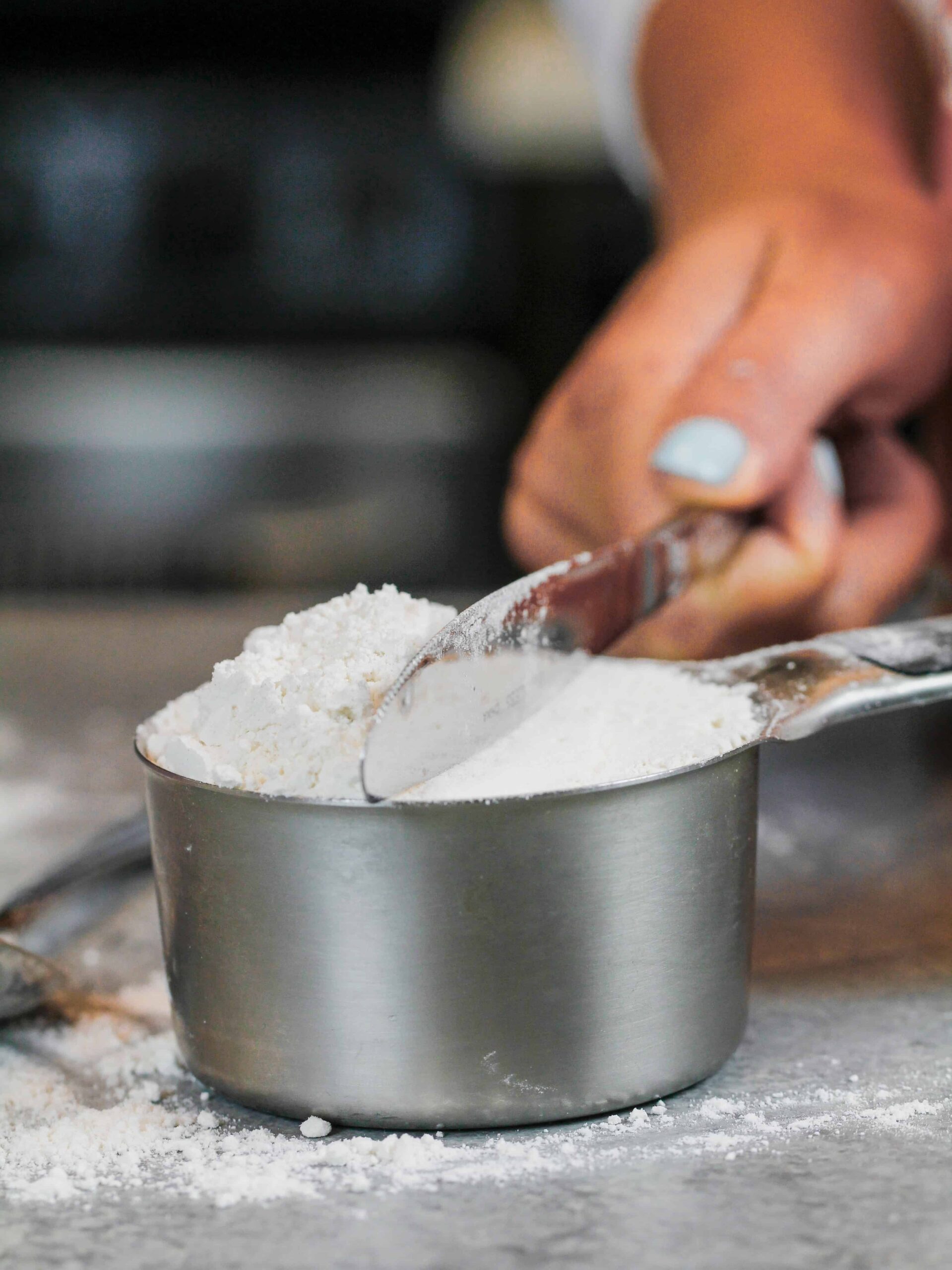 image of flour being leveled in a measuring cup