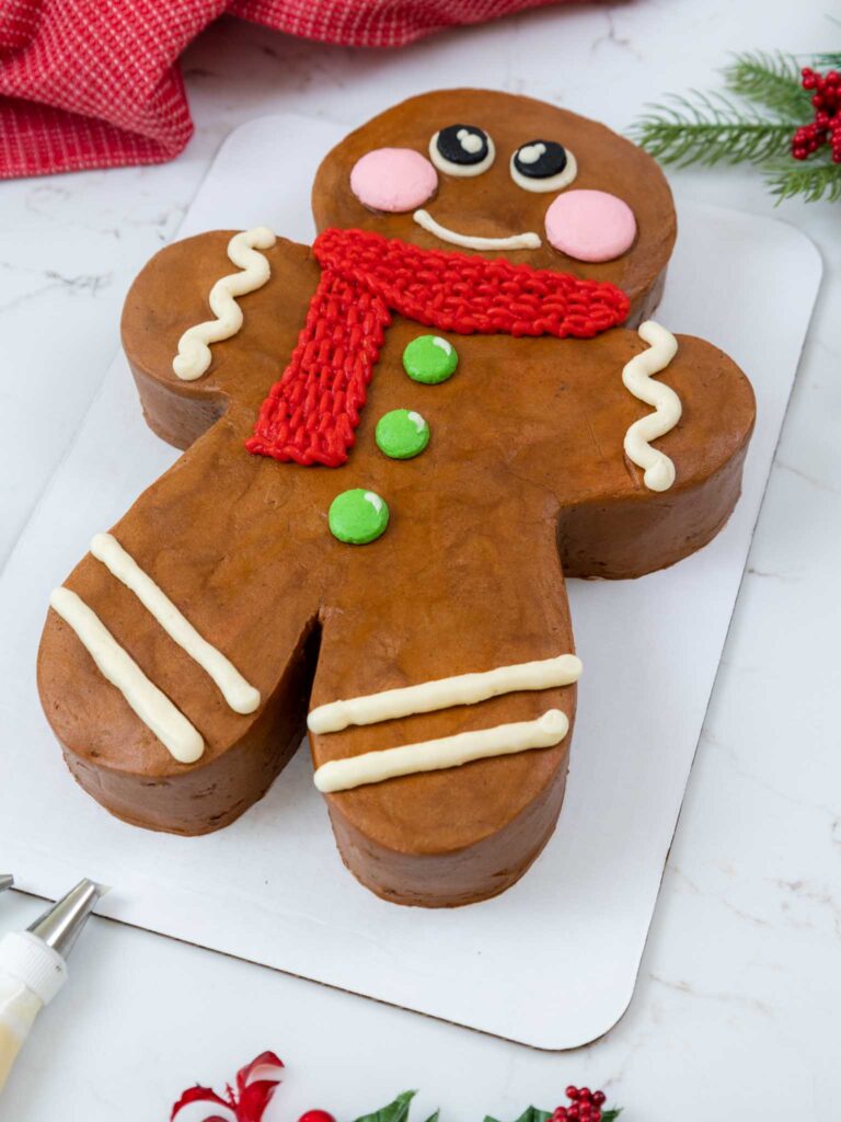 image of a gingerbread man cake that's been frosted with gingerbread buttercream frosting