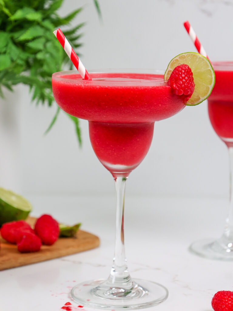 image of a frozen raspberry daiquiri that's been poured into a margarita glass