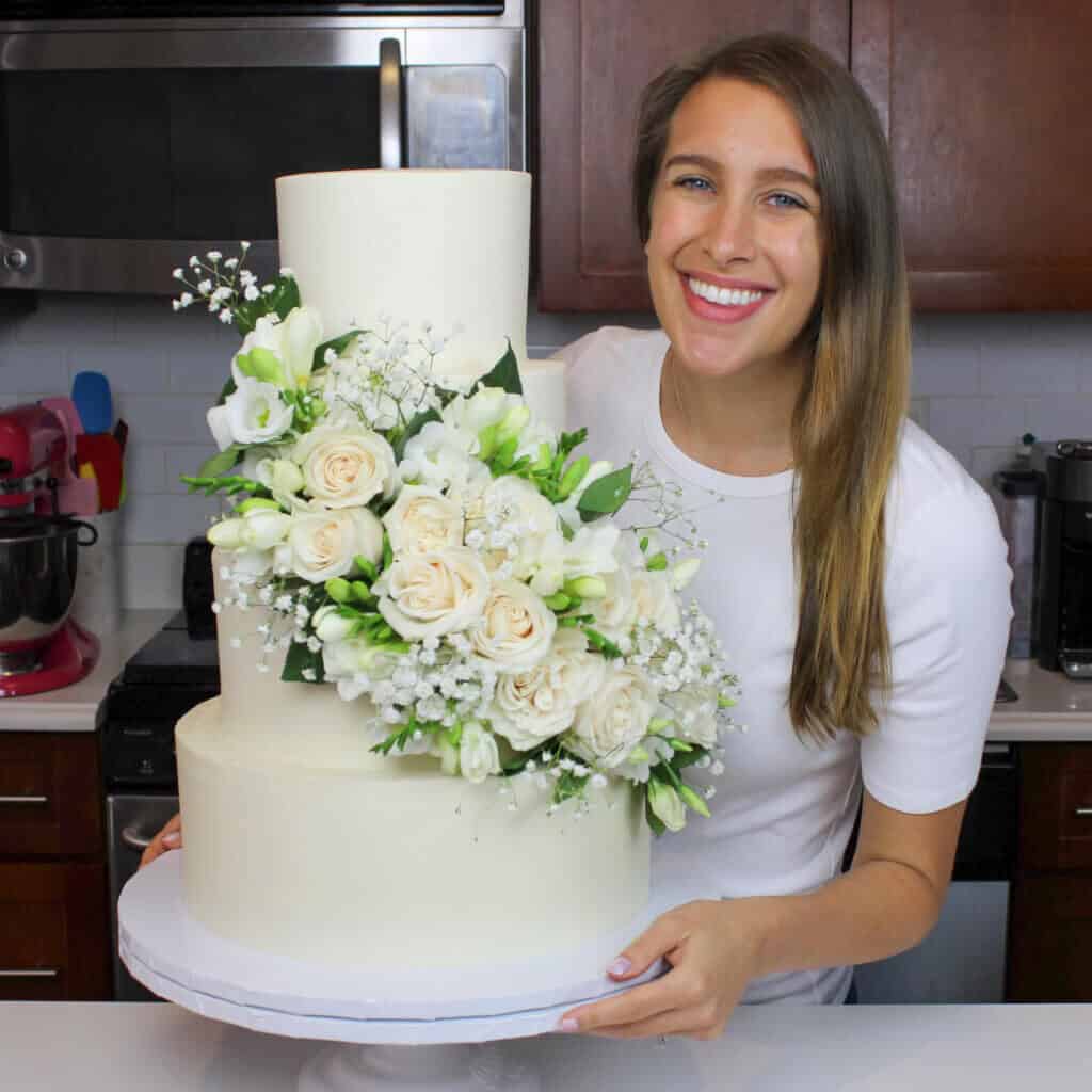 photo of chelsey white with her wedding cake sharing how many people it feed in her cake portion guide