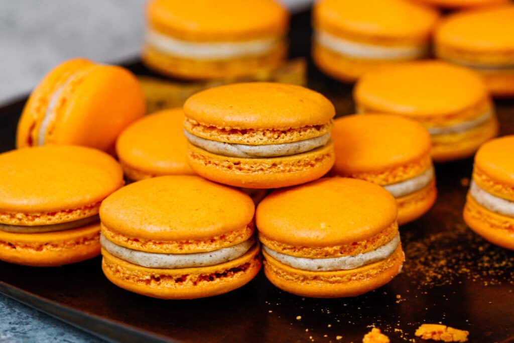 image of pumpkin macarons with a spiced buttercream and pumpkin pie filling