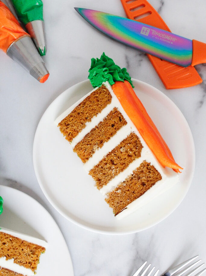 image of slice of moist carrot cake, frosted with cream cheese frosting