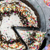 image of an oreo cream pie decorated with sprinkles and buttercream