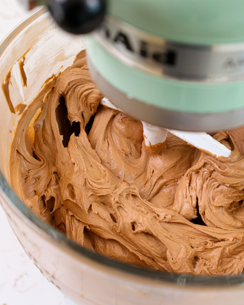 image of chocolate hazelnut buttercream being mixed in a kitchen aid