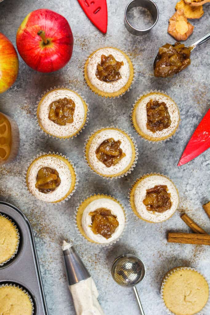 image of apple cider cupcakes shot overhead to show their apple pie topping and spiced buttercream frosting