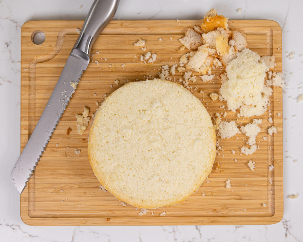 image of a white cake layer that's been leveled with serrated knife