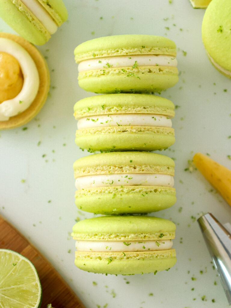 image of lime macarons stacked and are filled with lime curd and lime buttercream