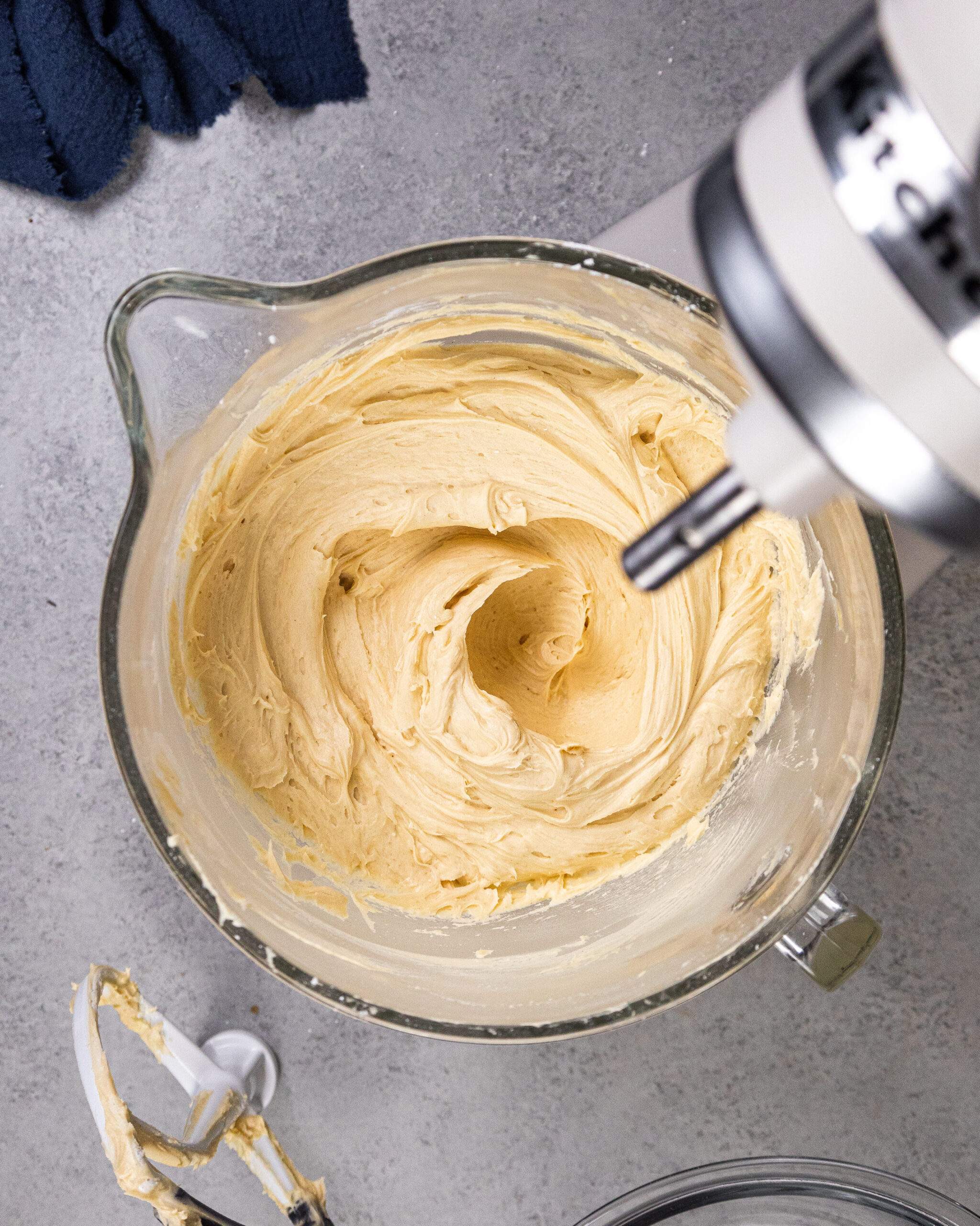 image of creamy peanut butter butter buttercream in the bowl of a kitchenaid stand mixer