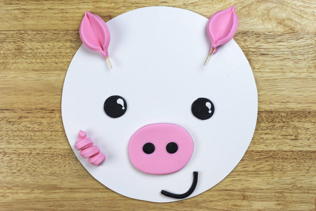 image of fondant pig face ready to be added to a cake