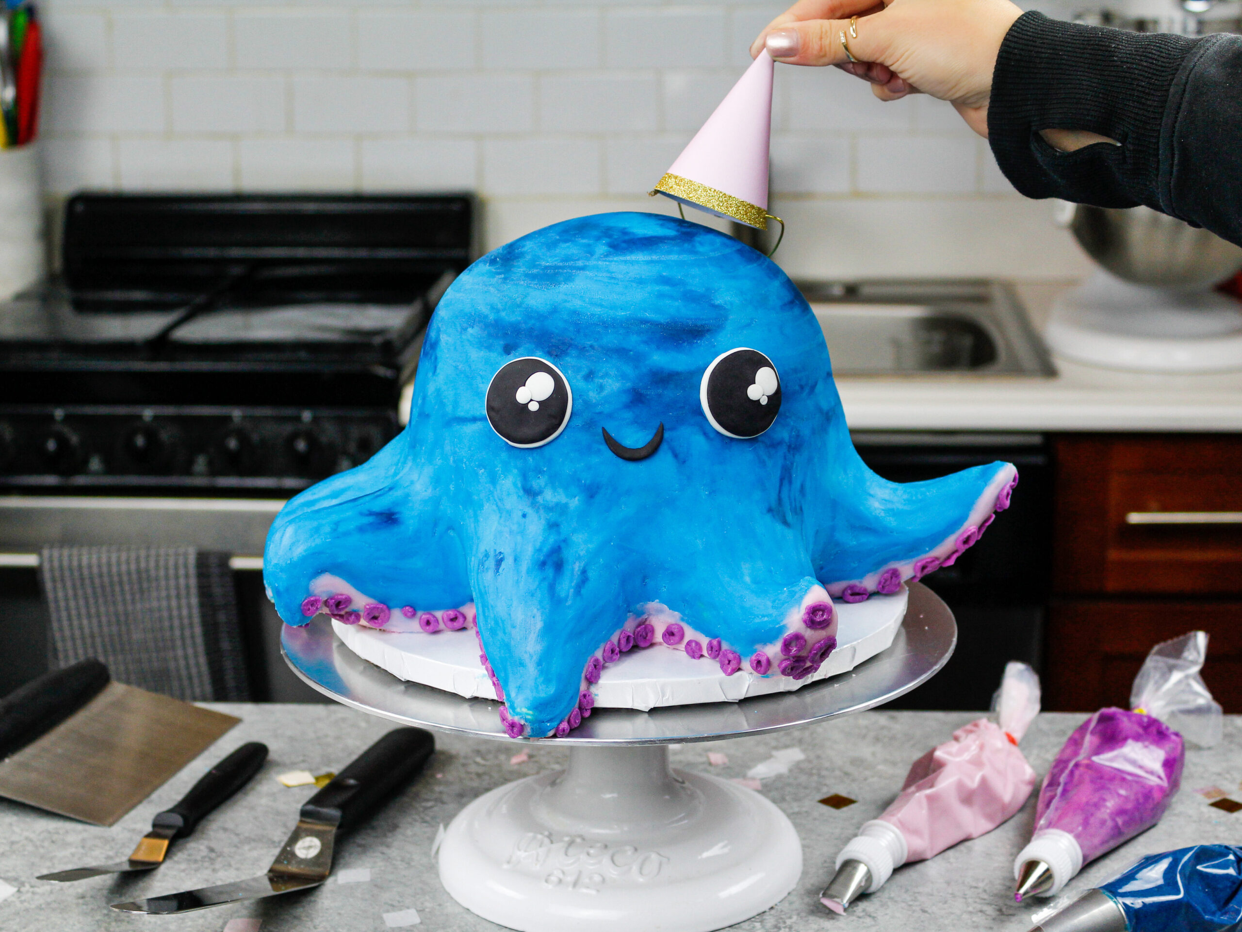 image of an octopus cake made for a birthday party with a party hat