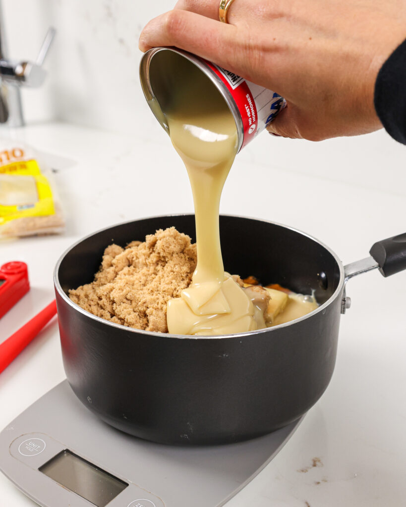 image of sweetened condensed milk being poured into a pot to make a thick caramel filling