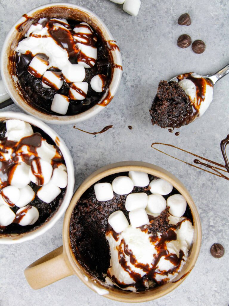 image of hot cocoa mug cake with spoonful scooped out to show how moist and fluffy the cake is