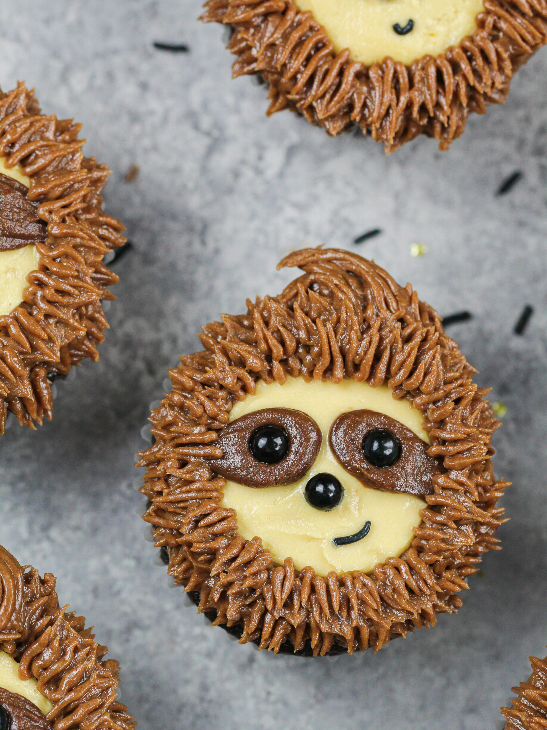 image of adorable sloth cupcakes made with chocolate cupcakes and chocolate peanut butter frosting