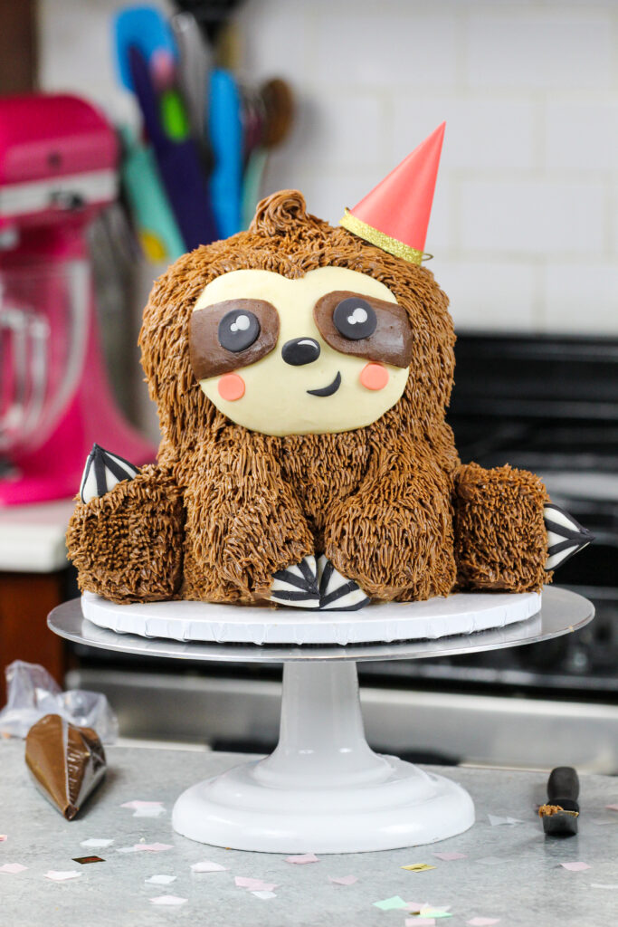 image of a sloth birthday cake made with chocolate cake layers and chocolate peanut butter buttercream