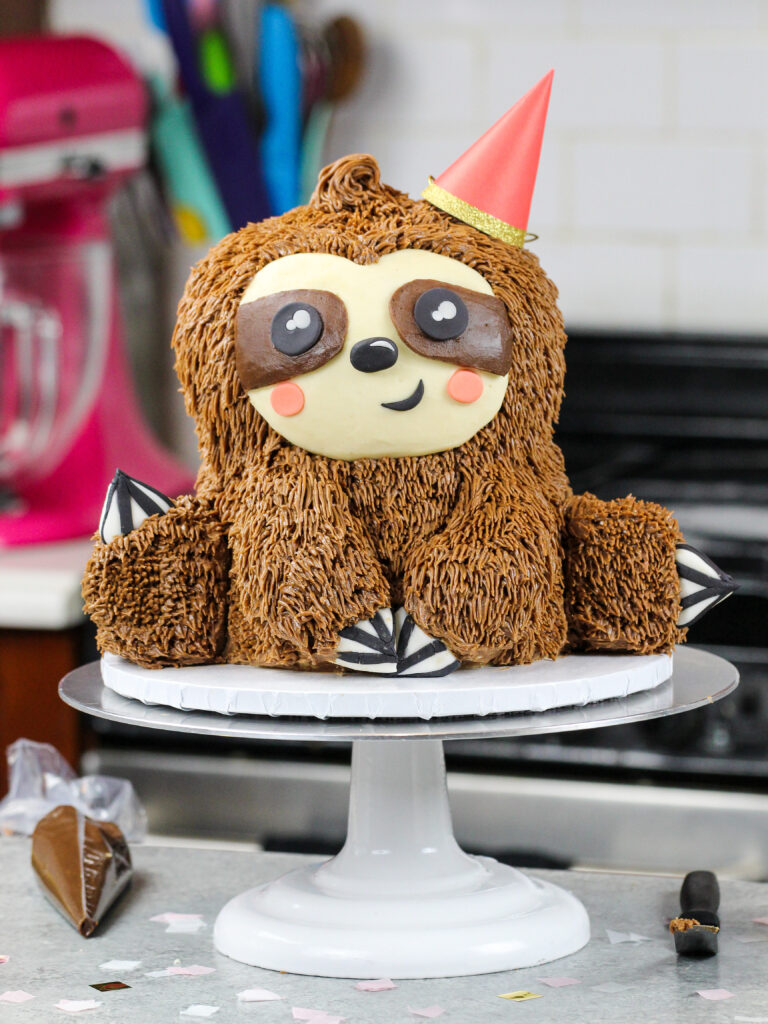 image of a sloth birthday cake made with chocolate cake layers and chocolate peanut butter buttercream