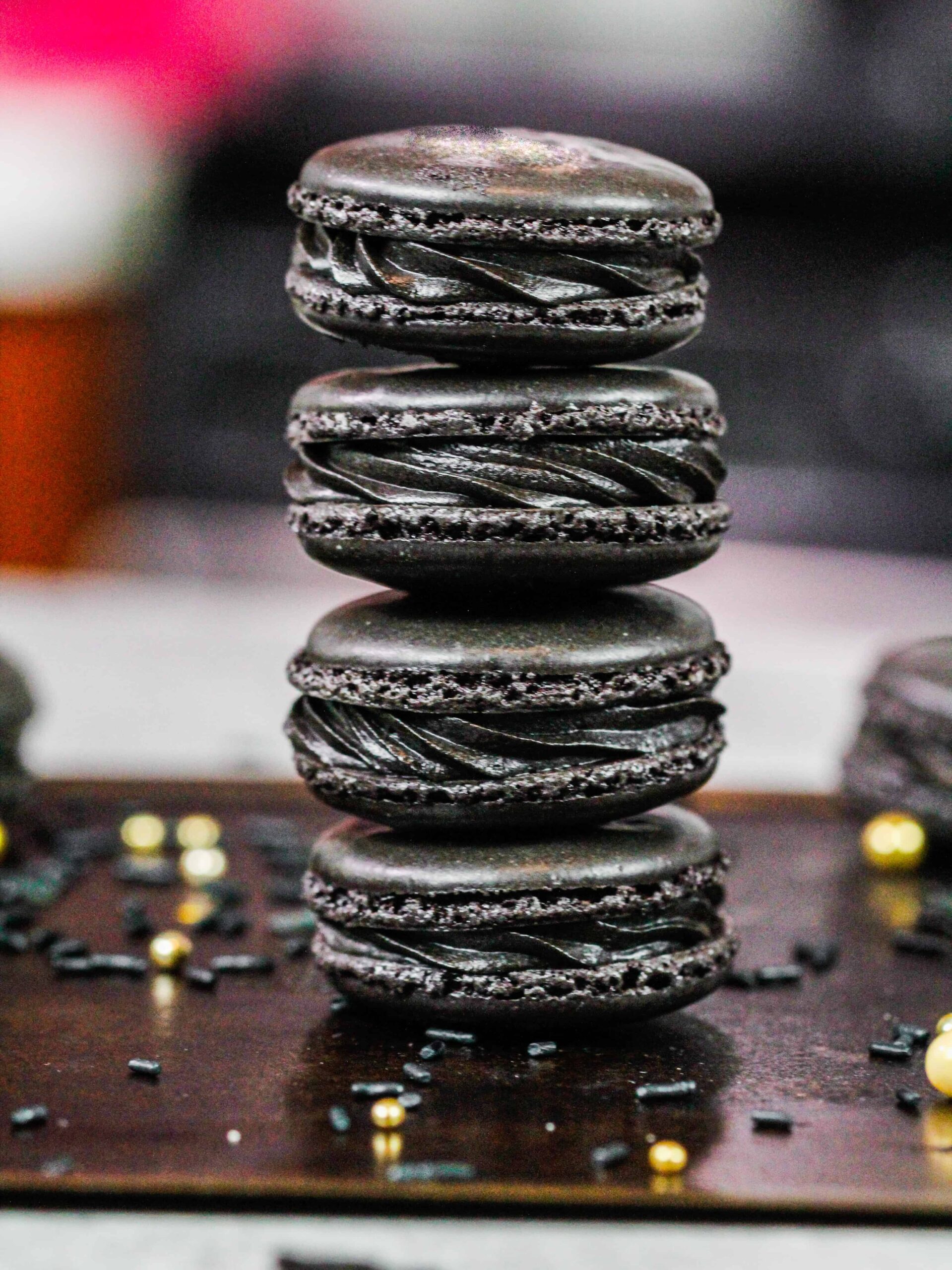 image of black macarons made using the french technique and filled with black cocoa buttercream