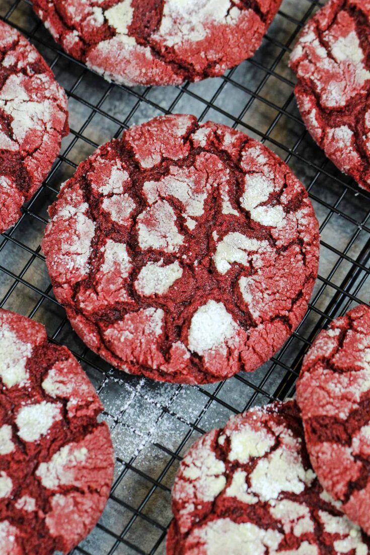 image of red velvet crinkle cookies cooling on a wire rack