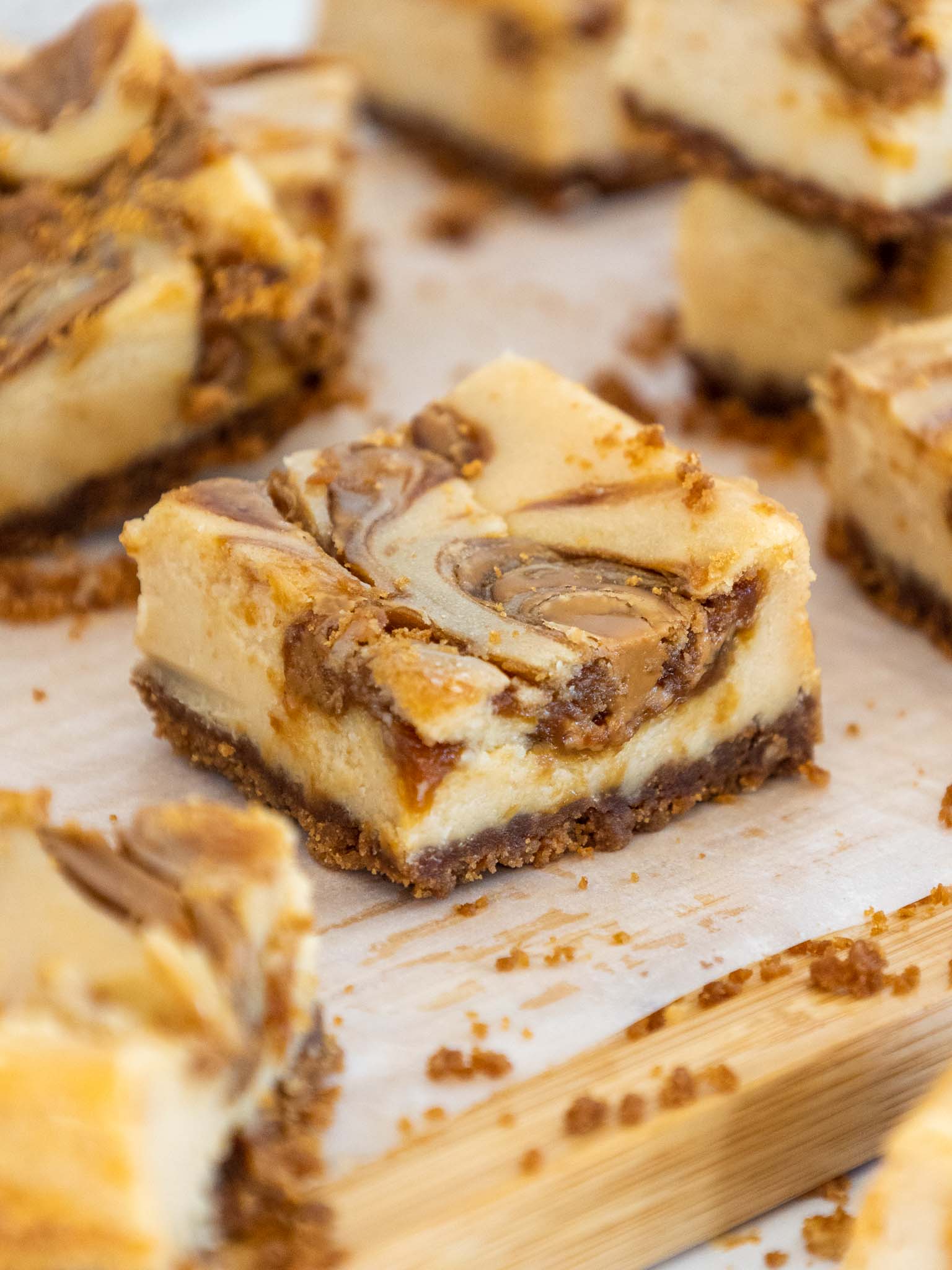 image of biscoff cheesecake bars cut up to show their biscoff cookie butter swirl