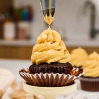 image of a cupcake being frosted with coffee buttercream frosting