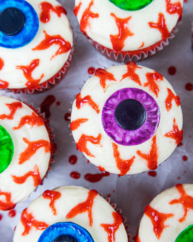 image of halloween eyeball cupcakes made with edible blood veins and red velvet cupcakes