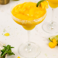 image of a frozen mango margaritas made with a lime sugar lime rim