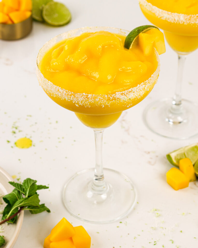 image of a frozen mango margaritas made with a lime sugar lime rim