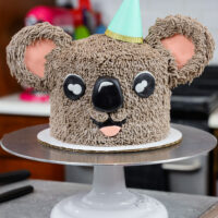 image of an adorable buttercream koala cake made with chocolate cake layers