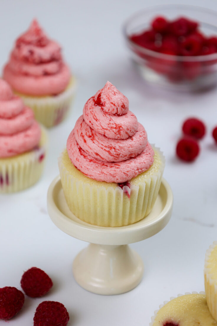 image of raspberry cupcakes made with vanilla cupcakes and raspberry buttercream