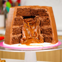 image of a rolo cake that's been decorated to look like a giant rolo and is filled with caramel