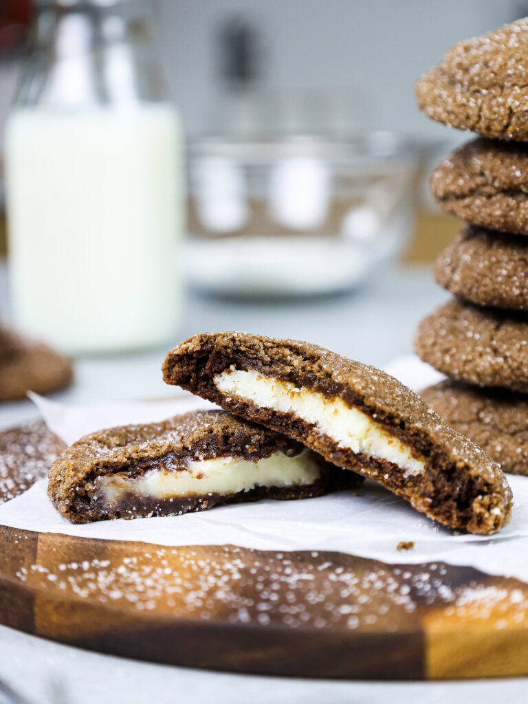 image of a chocolate cheesecake cooke that's been bitten into to show its creamy cheesecake filling