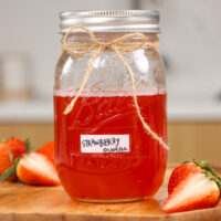 image of strawberry simple syrup in a mason jar