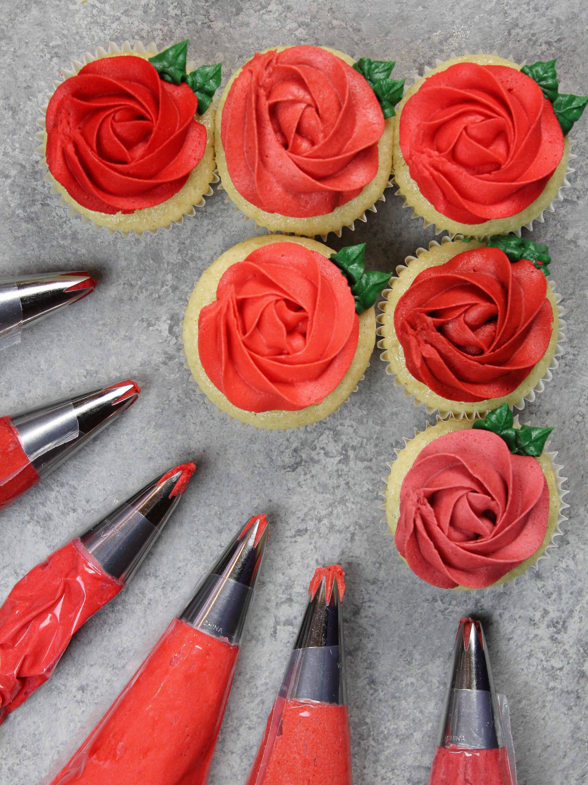 image of cupcakes decorated with red buttercream rosettes
