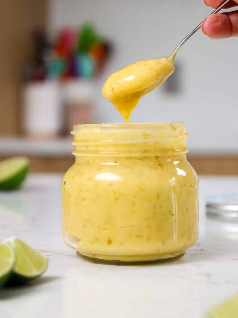 image of homemade lime curd being scooped out of a glass jar