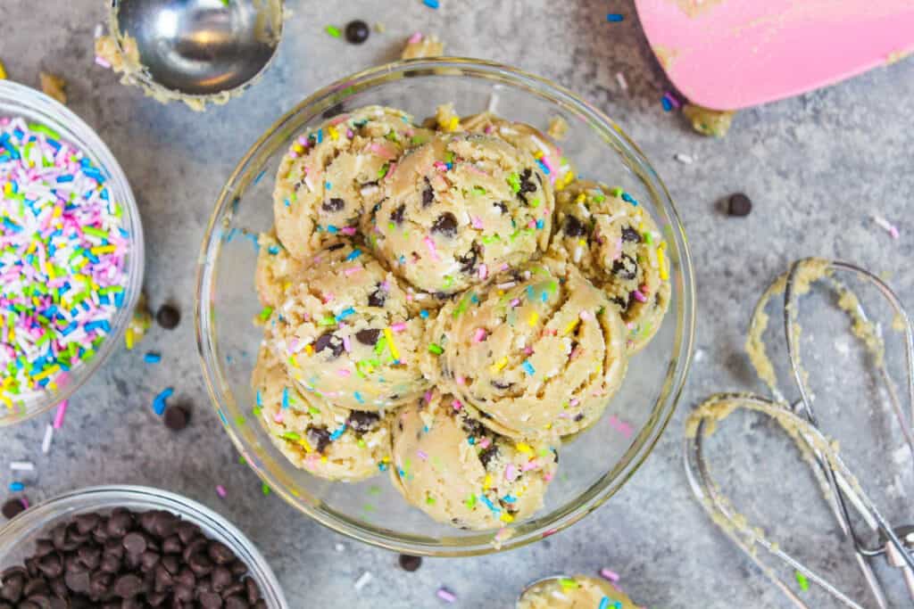 image of vegan edible cookie dough scooped into a bowl to be eaten 
that's shared as part of a no bake dessert round up