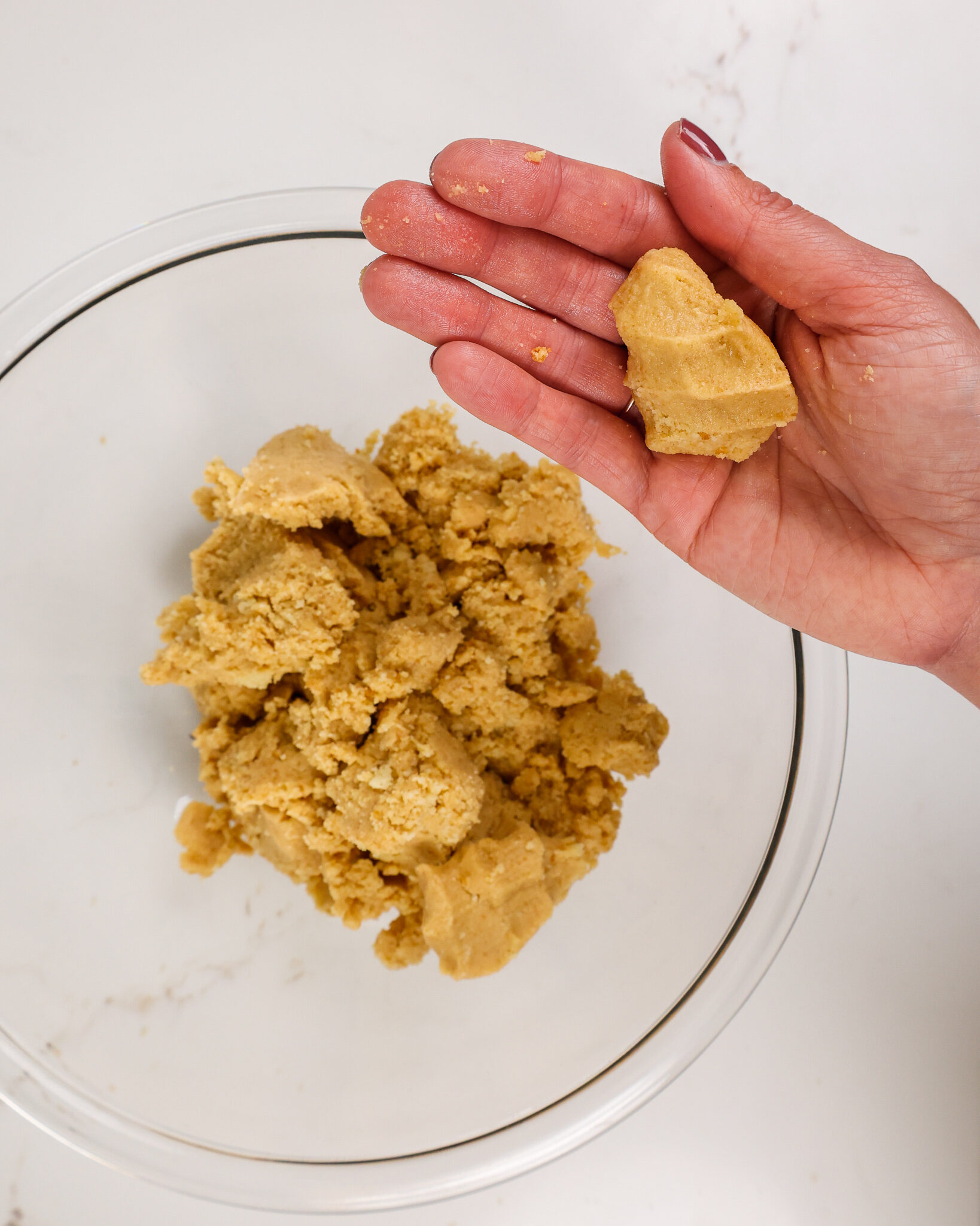 image of shortbread cookies that have been crushed and mixed with butter and are now ready to be used to make a cake crust