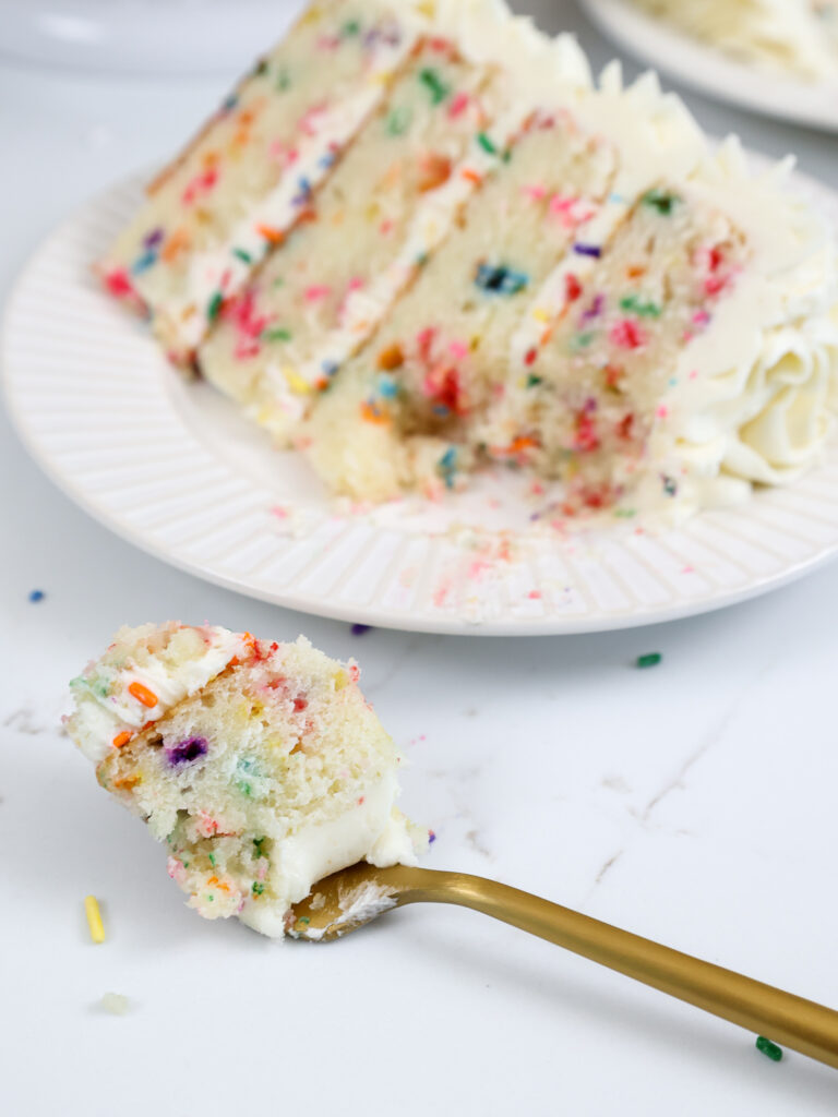 image of a funfetti cake layer that's been cut into with a fork