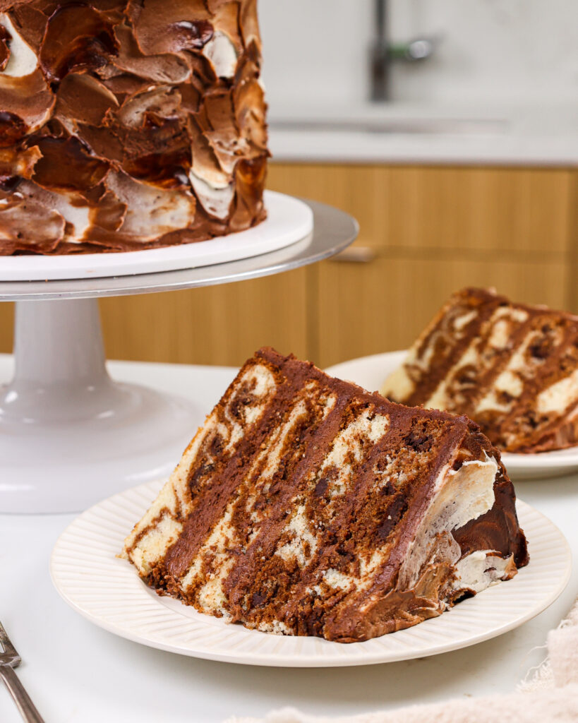 image of a slice of moist marble cake on a plate that's ready to be eaten