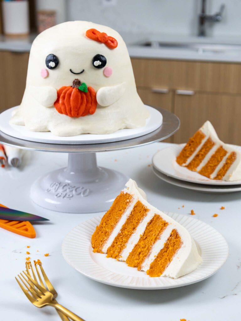 image of a cute ghost cake that's been frosted with buttercream frosting and made with pumpkin cake layers