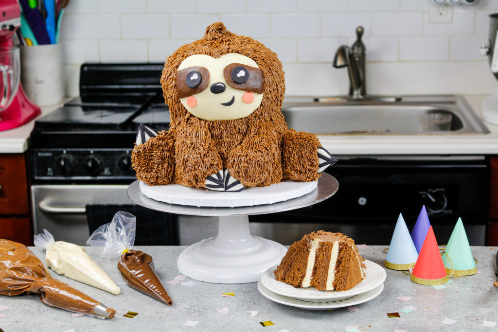 image of a sloth birthday cake made with chocolate cake layers and chocolate peanut butter buttercream