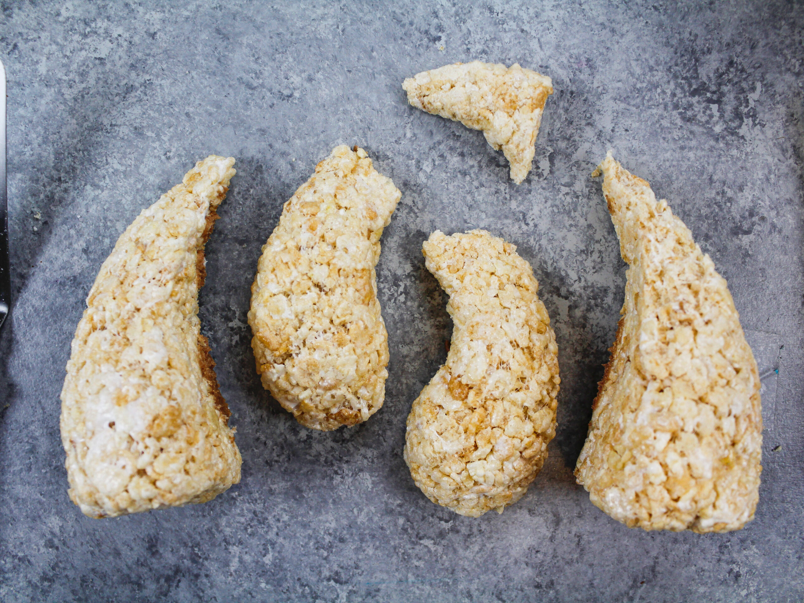 image of rice krispies shaped into legs and arms to make a sloth cake