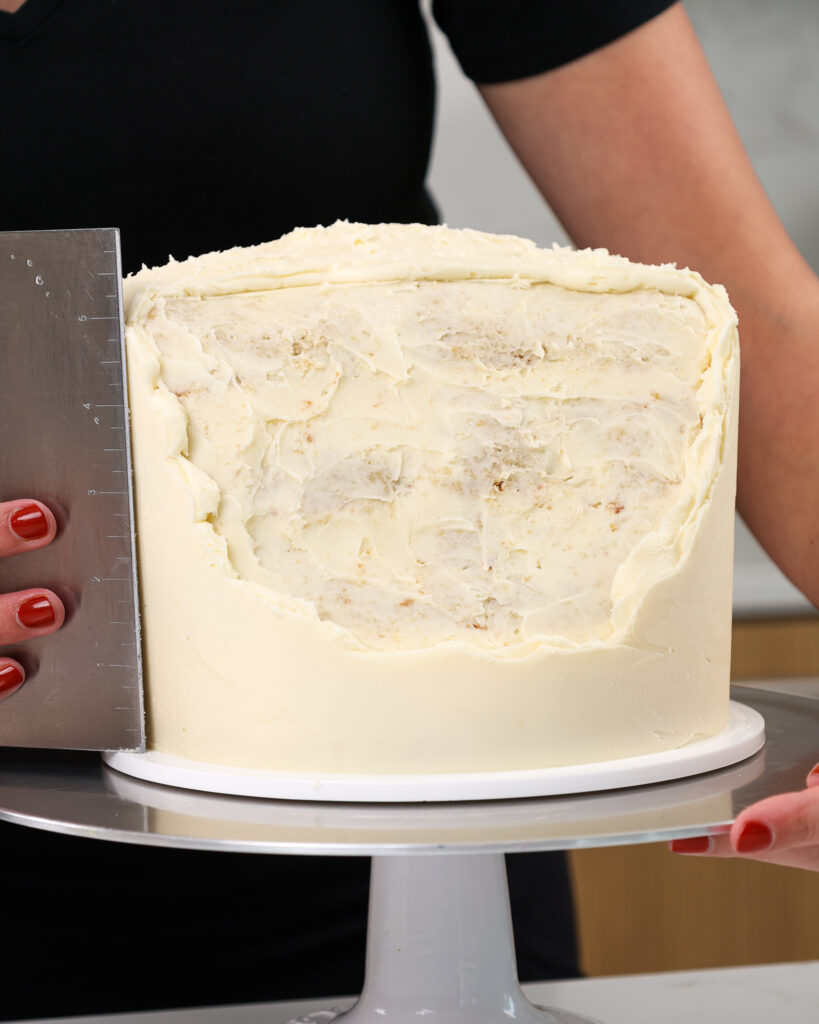 image of a beach cake being frosted before adding in the gelatin ocean