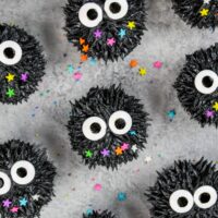 image of soot sprite cupcakes made with black cocoa frosting and candy sprinkle eyes