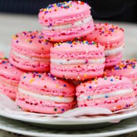 image of birthday cake macarons stacked on a plate