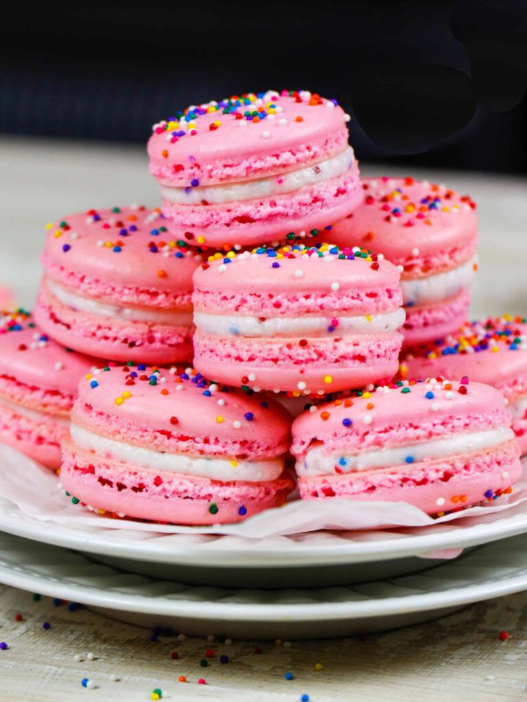 image of birthday cake macarons stacked on a plate